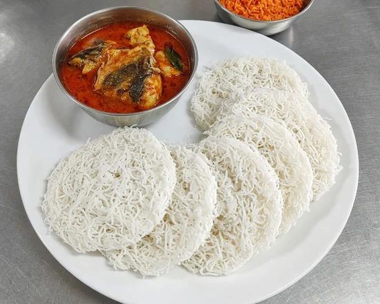String hoppers with a bowl of fish curry and coconut sambol